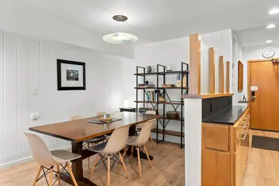 a kitchen and dining room with a wooden table and chairs at Palisades Tahoe Lodge Rentals Premium Studio Loft #333 in Olympic Valley