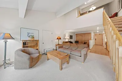 a living room with a couch and a table at Palisades Tahoe Lodge Rentals Studio Loft #353 in Olympic Valley