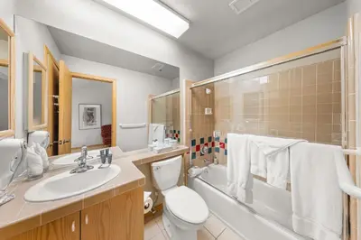 a bathroom with a sink and a toilet and a tub at Palisades Tahoe Lodge Rentals Studio Loft #353 in Olympic Valley