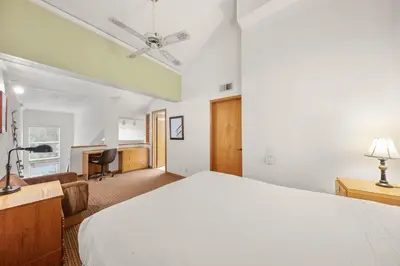 a bedroom with a white bed and a desk at Palisades Tahoe Lodge Rentals Studio Loft #329 in Olympic Valley