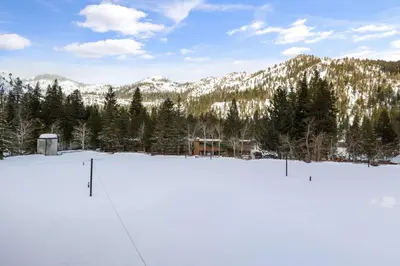 a snow covered parking lot with mountains in the background at Palisades Tahoe Lodge Rentals Studio Loft #329 in Olympic Valley