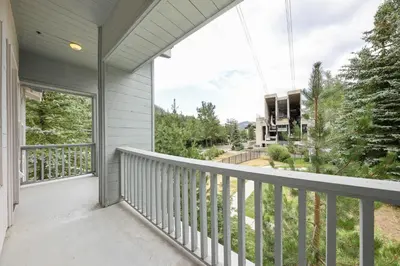 a balcony with a view of a house at Palisades Tahoe Lodge Rentals Premium Two Bedroom #805 in Olympic Valley