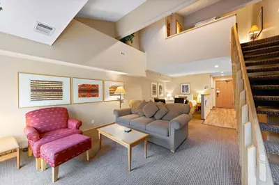 a living room with a couch and a chair at Palisades Tahoe Lodge Rentals Studio Loft #334 in Olympic Valley