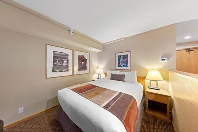 a hotel room with a large bed and a desk at Palisades Tahoe Lodge Rentals Studio Loft #334 in Olympic Valley
