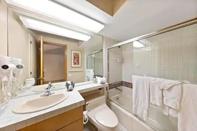 a bathroom with a sink and a toilet and a tub at Palisades Tahoe Lodge Rentals Studio Loft #334 in Olympic Valley