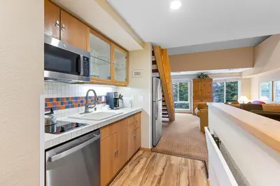 a kitchen with a sink and a microwave at Palisades Tahoe Lodge Rentals Studio Loft #334 in Olympic Valley