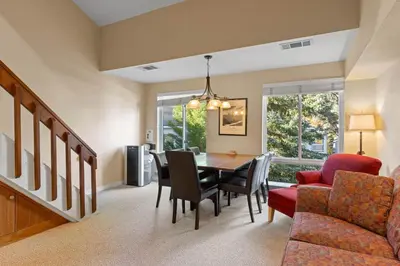 a living room with a dining room table and chairs at Palisades Tahoe Lodge Rentals Premium Studio Loft #313 in Olympic Valley