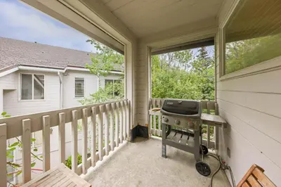 a screened in porch with a grill on it at Palisades Tahoe Lodge Rentals Two Bedroom #422 in Olympic Valley