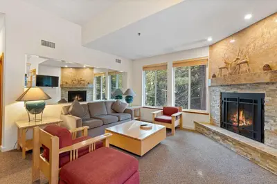 a living room with a couch and a fireplace at Palisades Tahoe Lodge Rentals Two Bedroom #521 in Olympic Valley