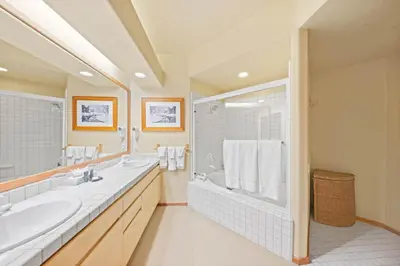 a bathroom with a tub and a sink and a shower at Palisades Tahoe Lodge Rentals Two Bedroom #512 in Olympic Valley