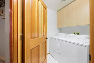 a kitchen with a washer and dryer next to a door at Palisades Tahoe Lodge Rentals Two Bedroom #512 in Olympic Valley