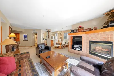 a living room with a couch and a fireplace at Palisades Tahoe Lodge Rentals Two Bedroom #512 in Olympic Valley