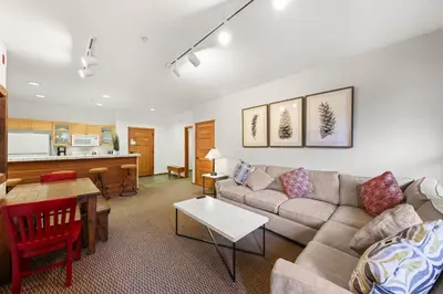 a living room with a couch and a table at Palisades Tahoe Lodge Rentals Two Bedroom #703 in Olympic Valley