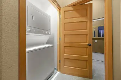 a door to a laundry room with a washer and dryer at Palisades Tahoe Lodge Rentals Two Bedroom #804 in Olympic Valley