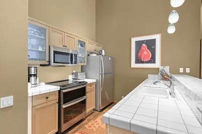 a kitchen with a refrigerator and a sink at Palisades Tahoe Lodge Rentals Two Bedroom #804 in Olympic Valley