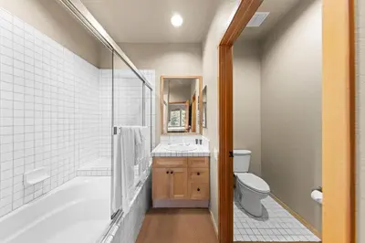 a bathroom with a tub and a toilet and a sink at Palisades Tahoe Lodge Rentals Two Bedroom #809 in Olympic Valley