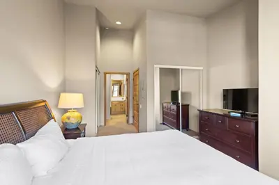 a bedroom with a bed and a flat screen tv at Palisades Tahoe Lodge Rentals Two Bedroom #809 in Olympic Valley
