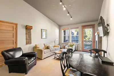 a living room with a table and chairs at Palisades Tahoe Lodge Rentals Two Bedroom #809 in Olympic Valley