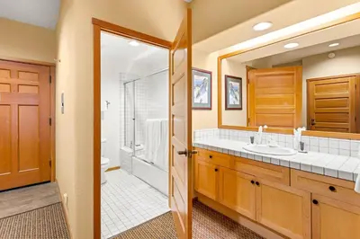 a bathroom with a double sink and a shower at Palisades Tahoe Lodge Rentals Two Bedroom #716 in Olympic Valley