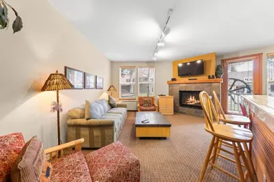 a living room with a couch and a fireplace at Palisades Tahoe Lodge Rentals Two Bedroom #716 in Olympic Valley