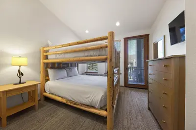 a bedroom with a bunk bed and a dresser at Two Bedroom #801 in Olympic Valley
