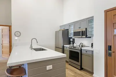 a kitchen with white counters and stainless steel appliances at Two Bedroom #801 in Olympic Valley