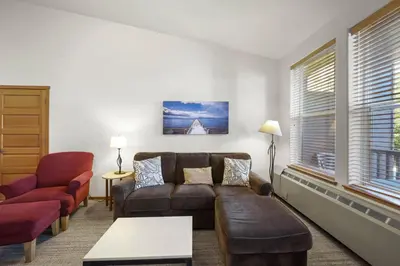 a living room with a couch and a chair at Two Bedroom #801 in Olympic Valley