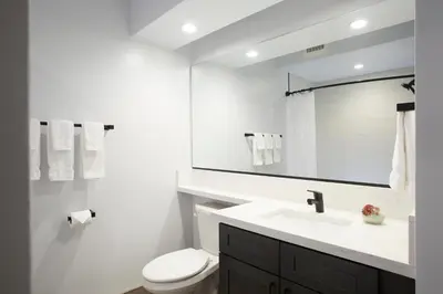 a white bathroom with a sink and a toilet at Palisades Tahoe Lodge Rentals Premium Studio #105 in Olympic Valley