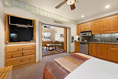 a bedroom with a bed and a flat screen tv at Palisades Tahoe Lodge Rentals Premium Studio #243 in Olympic Valley