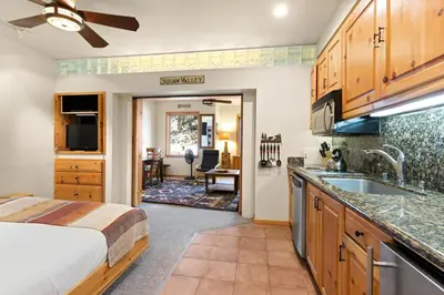 a bedroom with a bed and a kitchen with a sink at Palisades Tahoe Lodge Rentals Premium Studio #243 in Olympic Valley