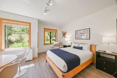 a bedroom with a bed and a table and chairs at Palisades Tahoe Lodge Rentals Premium Studio #149 in Olympic Valley