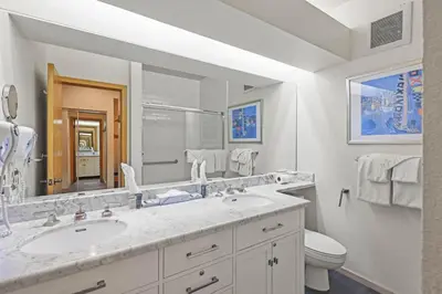 a bathroom with a sink and a toilet and a mirror at Palisades Tahoe Lodge Rentals Premium Studio #149 in Olympic Valley
