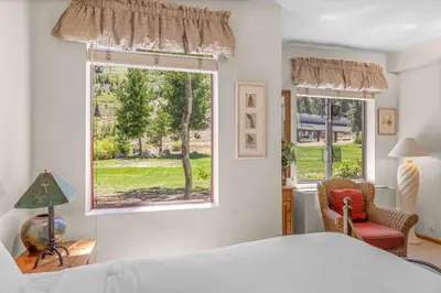 a bedroom with a bed and a window at Palisades Tahoe Lodge Rentals Studio #143 in Olympic Valley