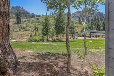 a view of a park with trees and a building at Palisades Tahoe Lodge Rentals Studio #143 in Olympic Valley