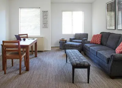 a living room with a couch and a table at Palisades Tahoe Lodge Rentals Premium Studio #252 in Olympic Valley