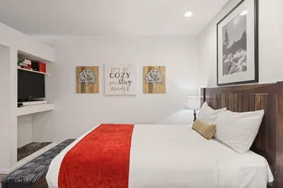 a bedroom with a bed and a tv in it at Palisades Tahoe Lodge Rentals Premium Studio #252 in Olympic Valley