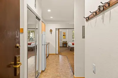 a hallway with a door leading to a bedroom at Palisades Tahoe Lodge Rentals Studio #144 in Olympic Valley