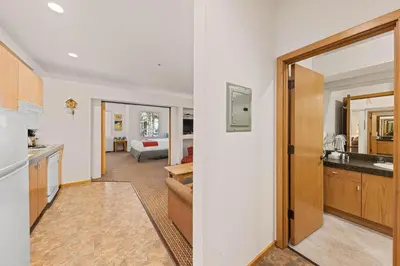 a room with a kitchen and a living room at Palisades Tahoe Lodge Rentals Studio #144 in Olympic Valley