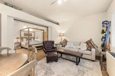 a living room with a couch and a bed at Palisades Tahoe Lodge Rentals Studio #146 in Olympic Valley