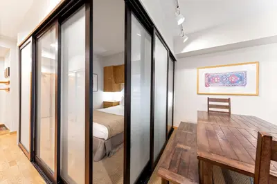 a room with a table and a bed in a room at Palisades Tahoe Lodge Rentals Studio #110 in Olympic Valley