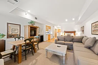 a living room with a couch and a table at Palisades Tahoe Lodge Rentals Studio #111 in Olympic Valley