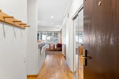 a hallway with a door leading to a dining room at Palisades Tahoe Lodge Rentals Studio #115 in Olympic Valley