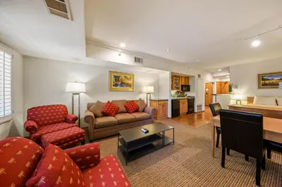 a living room with a couch and a table at Palisades Tahoe Lodge Rentals Studio #203 in Olympic Valley