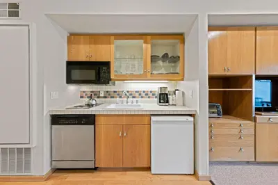 a kitchen with a sink and a dishwasher at Palisades Tahoe Lodge Rentals Studio #113 in Olympic Valley