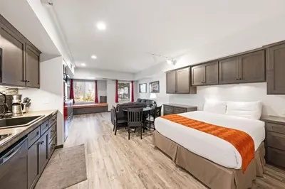 a hotel room with a bed and a kitchen at Palisades Tahoe Lodge Rentals Studio #117 in Olympic Valley