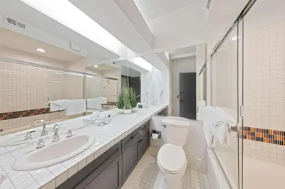 a white bathroom with a toilet and a sink at Palisades Tahoe Lodge Rentals Studio #117 in Olympic Valley