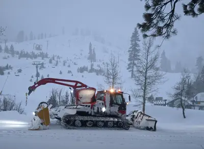a bulldozer in the snow on a snow covered slope at Palisades Tahoe Lodge Rentals Studio #147 in Olympic Valley