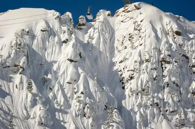 a mountain covered in snow with a ski lift at Palisades Tahoe Lodge Rentals Studio #151 in Olympic Valley