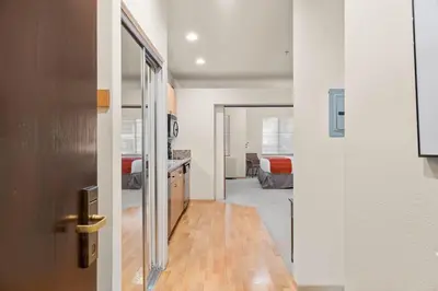 an open door to a room with a bedroom at Palisades Tahoe Lodge Rentals Studio #152 in Olympic Valley