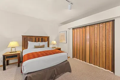 a bedroom with a large bed and two night stands at Palisades Tahoe Lodge Rentals Studio #152 in Olympic Valley
